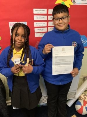 Two people holding a piece of paperDescription automatically generated with low confidence