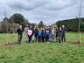 A group of people standing in a fieldDescription automatically generated with medium confidence