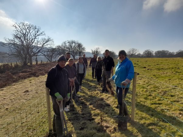 A group of people standing in a fieldDescription automatically generated with medium confidence