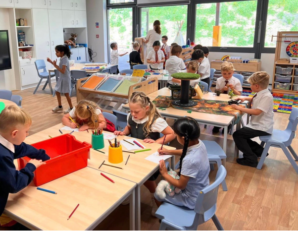 A group of children in a classroomDescription automatically generated