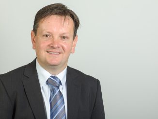 Man standing in front of a grey background