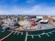 Panoramic aerial view of Cardiff Bay on a sunny day with the city centre in the background.