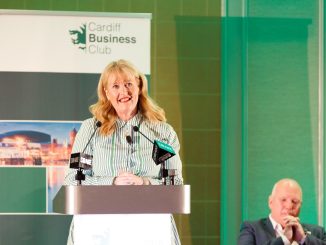 Woman standing at a podium giving a speech