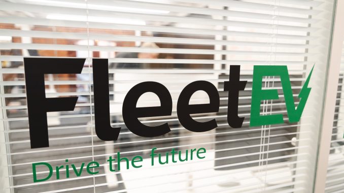 An image of the FleetEV logo against an office window.