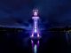 A photo taken at night of Roath Park's lighthouse lit up in City Hospice purple for the Light Up A Life appeal.