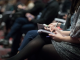 A close up of a women making notes at a business event.