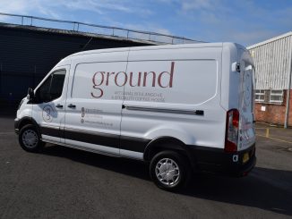A branded white van with the logo for 'Ground' written across the side.