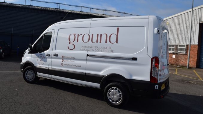 A branded white van with the logo for 'Ground' written across the side.