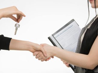 A real estate transaction with a handshake and key exchange, highlighting a home insurance document.