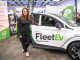 Hannah Williams stood in front of a branded FleetEV car.