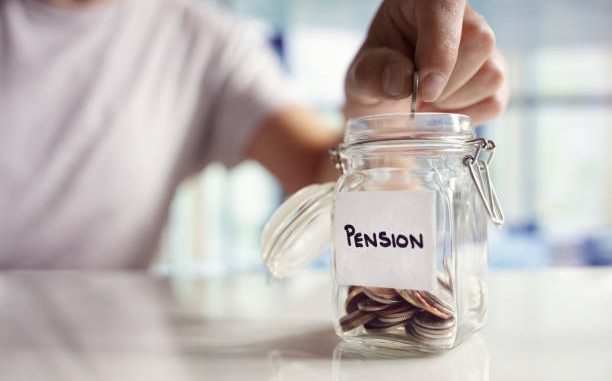 A person putting money into a glass jar labelled "pension".