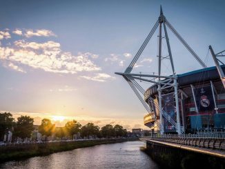 Scenic view of Principality Stadium by River Taff in Cardiff, Wales during sunset.