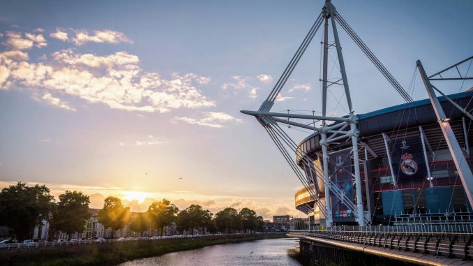 Scenic view of Principality Stadium by River Taff in Cardiff, Wales during sunset.