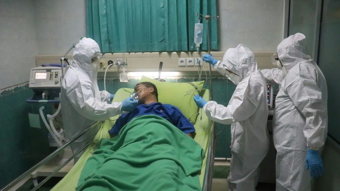 man in white scrub suit lying on hospital bed