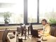 A person sat at an office desk in front of multiple monitors.