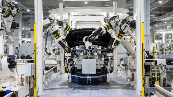 An electric vehicle in production at a factory.