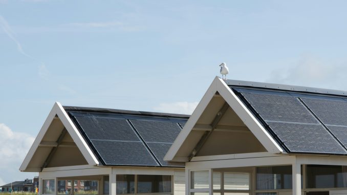 Two roof tops with solar panels.