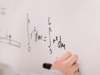 person writing on white paper