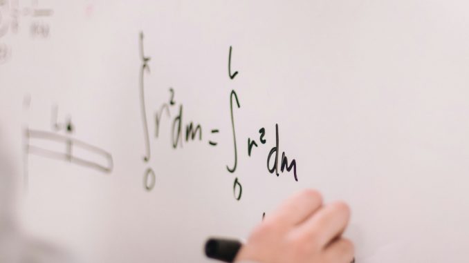 person writing on white paper
