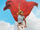 A child jumping in a Superman pose in front of the mural in The Red Dragon Centre