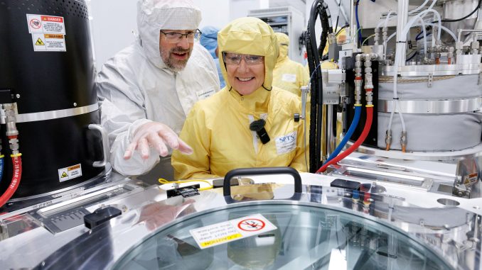 Andrew Evans and Jo Stevens looking at machinery at KLA.
