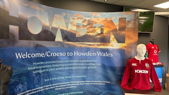The Howden Wales banner next to a signed Lions shirt at the Lions fundraising event.