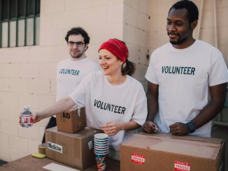 Volunteers distributing aid at an outdoor donation center, promoting social impact and diversity.