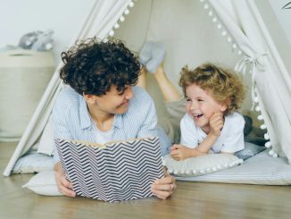 a woman reading a book to a child
