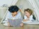 a woman reading a book to a child