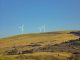 Scenic view of wind turbines on hills in Cymmer, Wales, showcasing renewable energy in a natural setting.