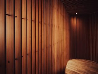 a room with wooden walls and a bench