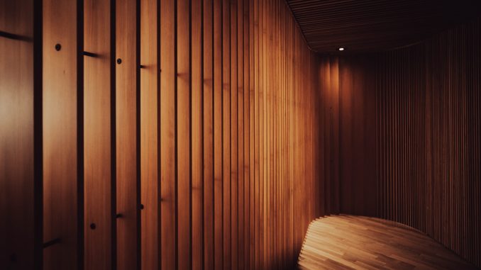 a room with wooden walls and a bench