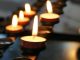lighted candles on black metal candle holder