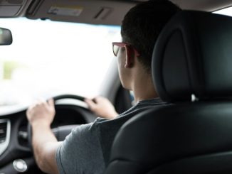 man driving car during daytime