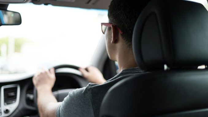 man driving car during daytime