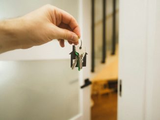 A hand holding a key to a door