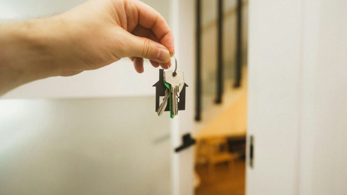 A hand holding a key to a door