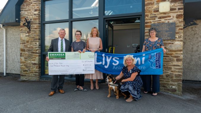 Alun Williams, CEO of Swansea Building Society, hands cheque for £2,000 to the team at Llys Nini.