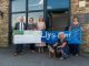 Alun Williams, CEO of Swansea Building Society, hands cheque for £2,000 to the team at Llys Nini.