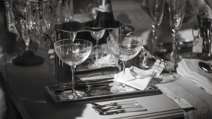 a table topped with wine glasses and silverware